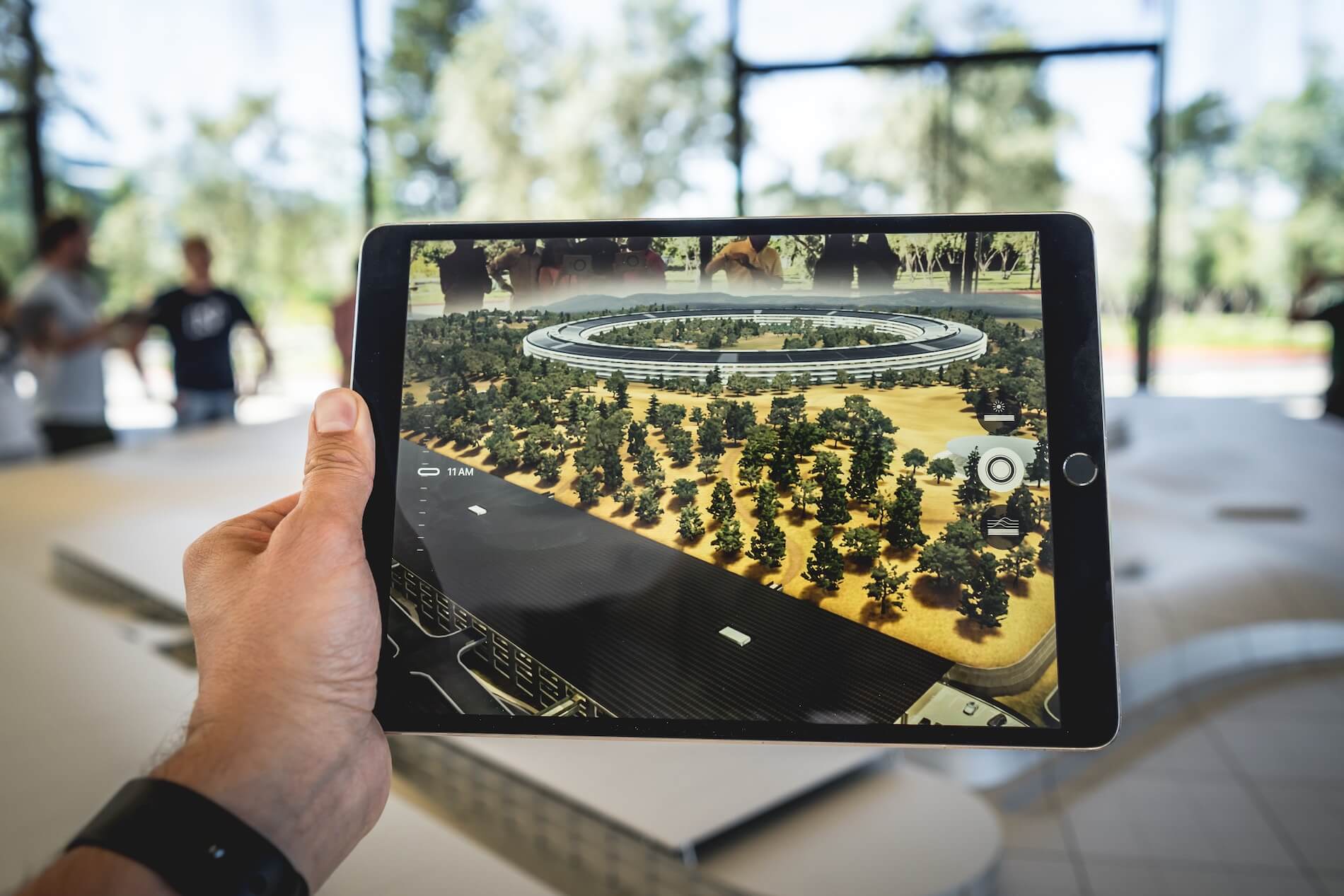 Person holding an iPad with an AR experience.